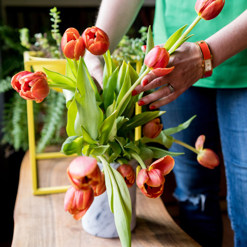 Brandi arranging flowers for a Brand*Eye Home designed interior