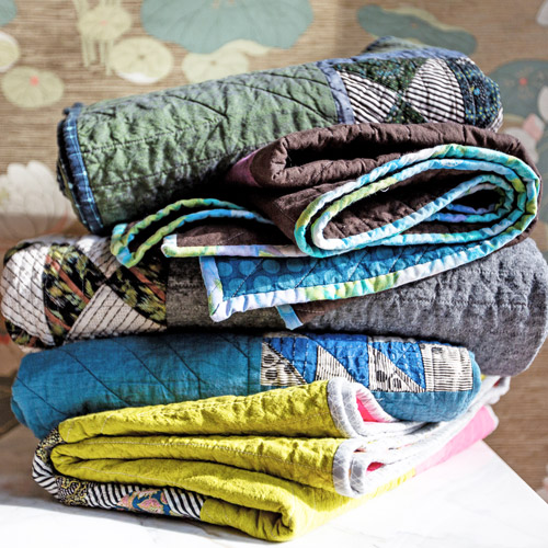a stack of handmade quilts from Brand*Eye Home