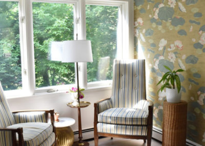 a sitting corner with striped chairs and water lily wallpaper designed by Brand*Eye Home