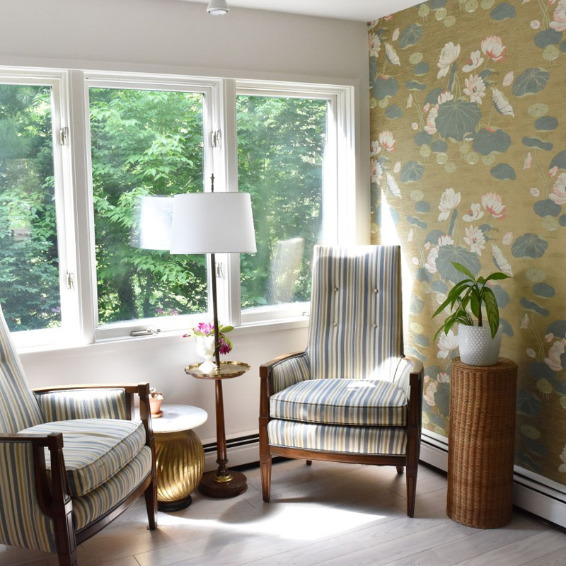 a sitting corner with striped chairs and water lily wallpaper designed by Brand*Eye Home