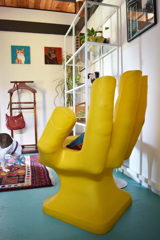 a yellow hand chair in a dressing room designed by Brand*Eye Home