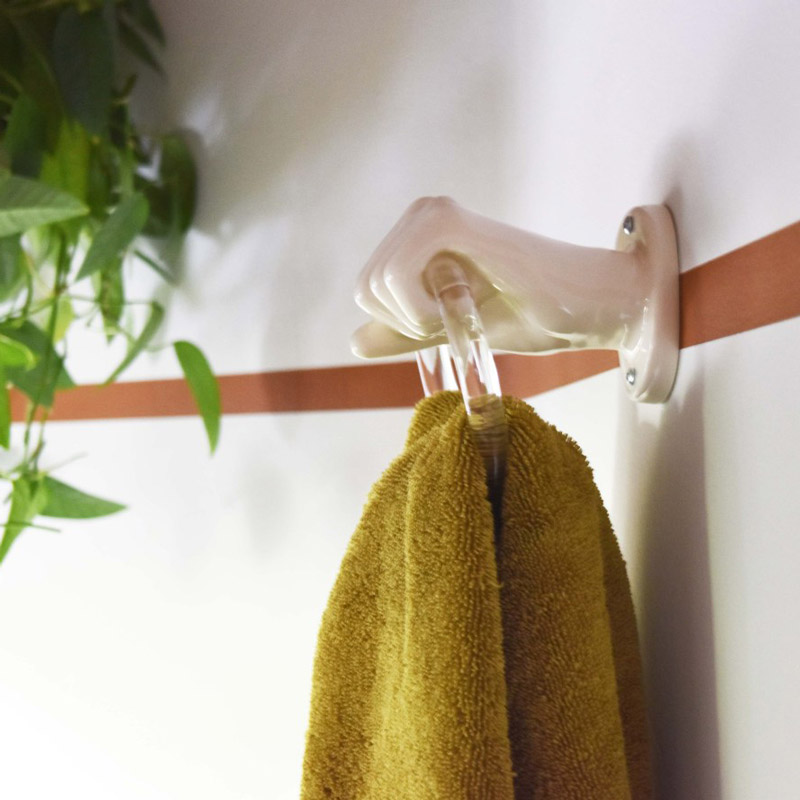 close-up of a hand-shaped towel hook in a bathroom designed by Brand*Eye Home