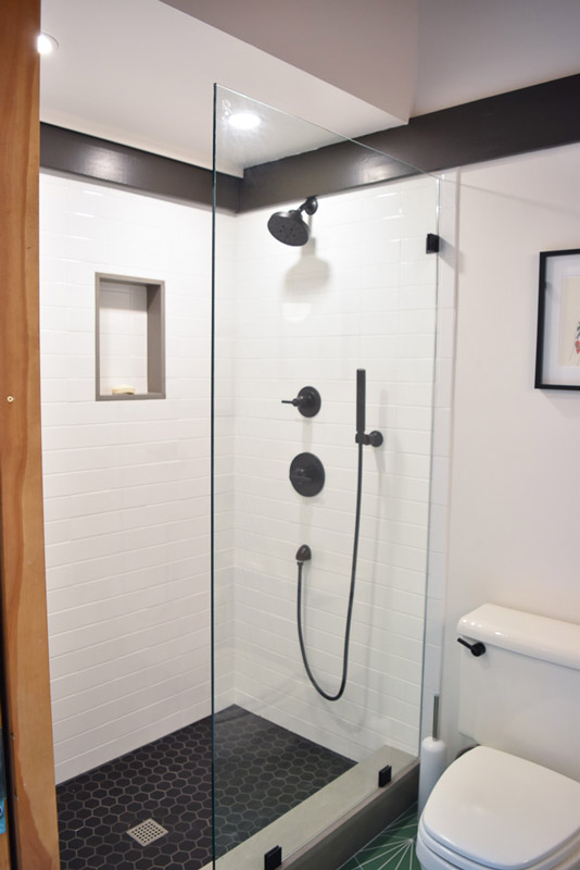 the stand-up shower in a bathroom designed by Brand*Eye Home