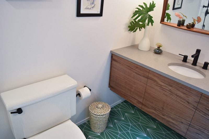 toilet and nearby sink counter in a bathroom designed by Brand*Eye Home