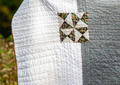 a white and grey patterned custom handmade quilt from Brand*Eye Home